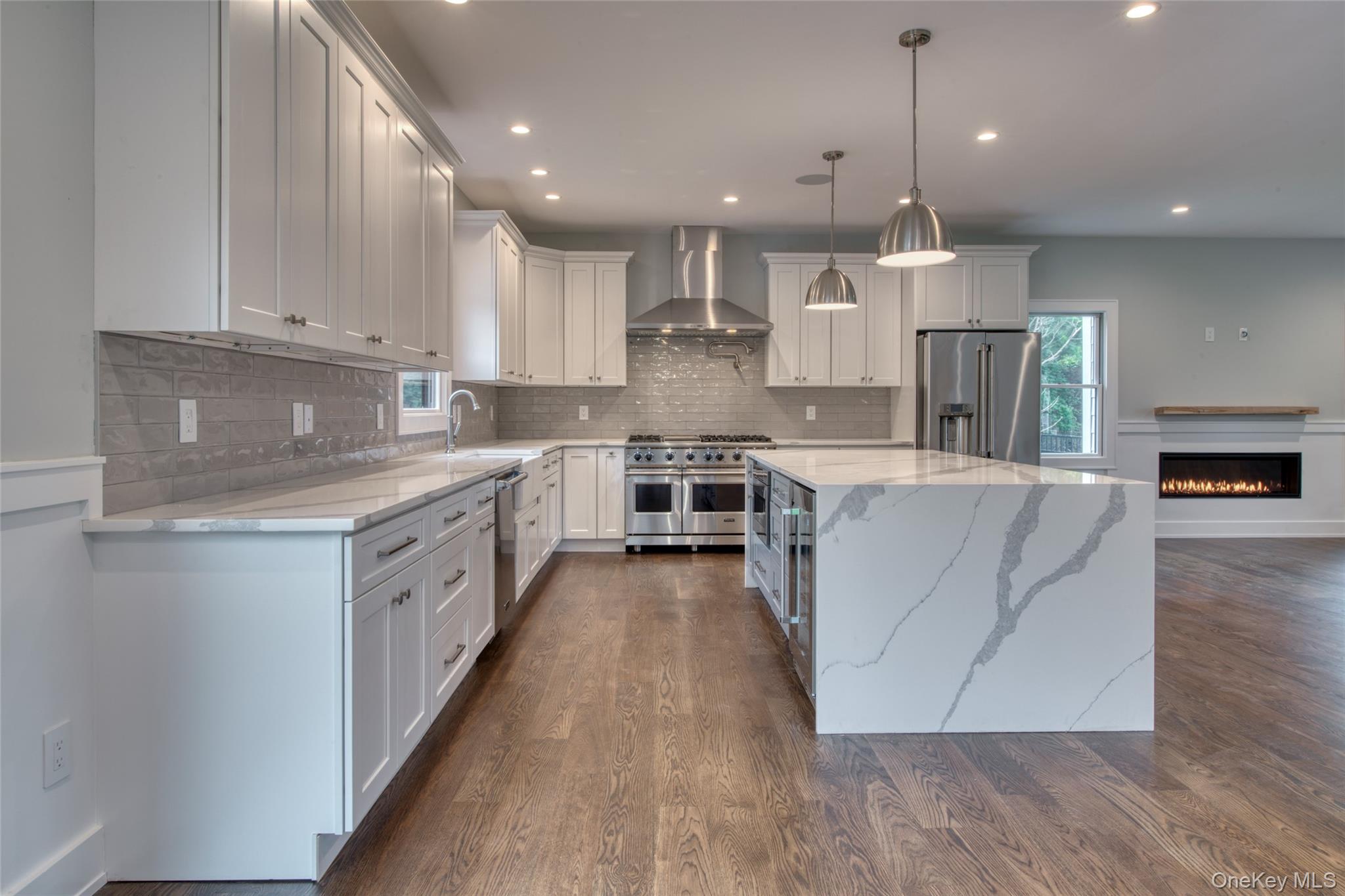 435 Maple Lane Greenport, NY 11944 - Photo 14 of 44 a large kitchen with stainless steel appliances granite countertop a lot of counter space and wooden floors