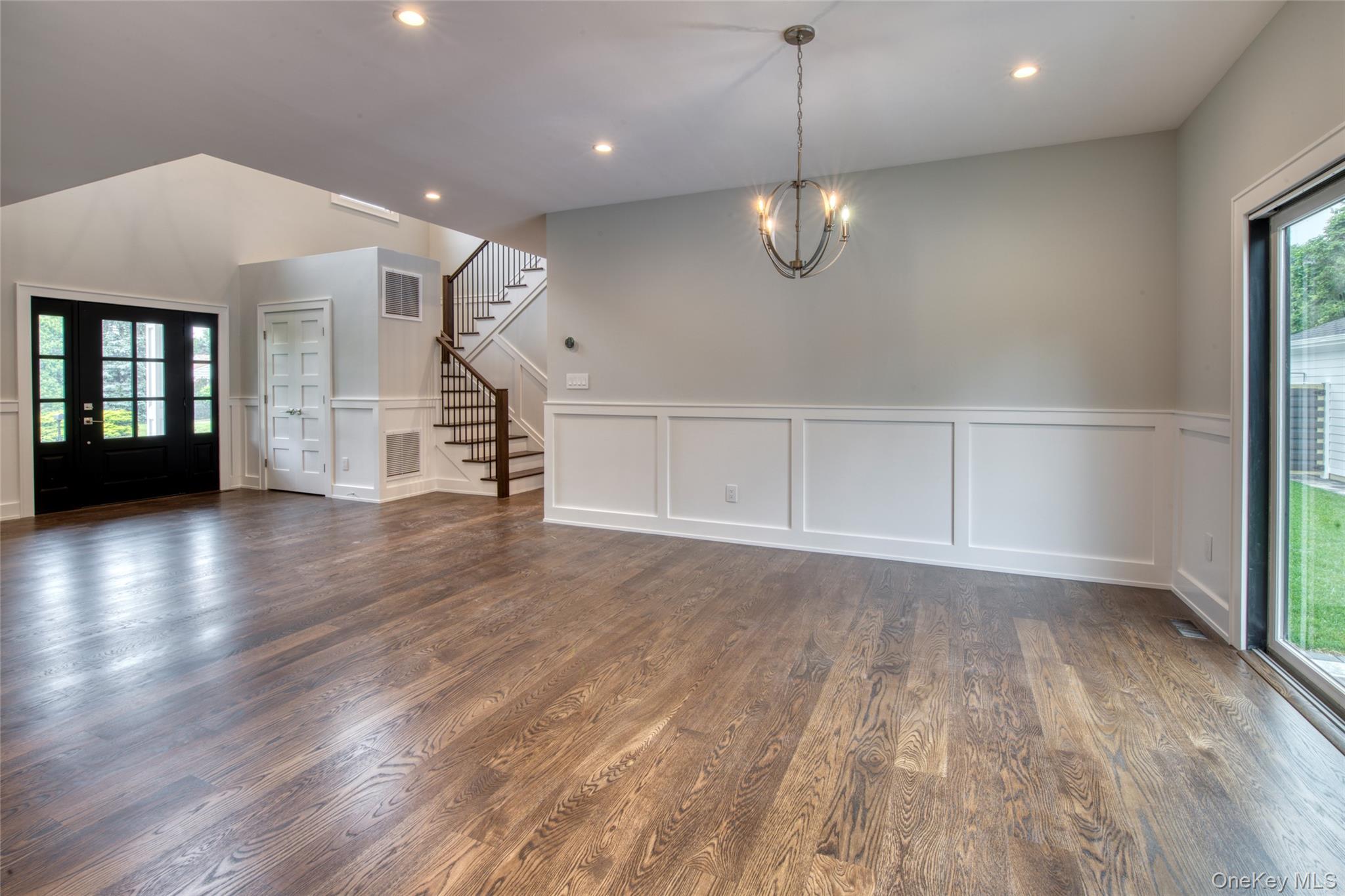 435 Maple Lane Greenport, NY 11944 - Photo 15 of 44 an empty room with wooden floor and windows