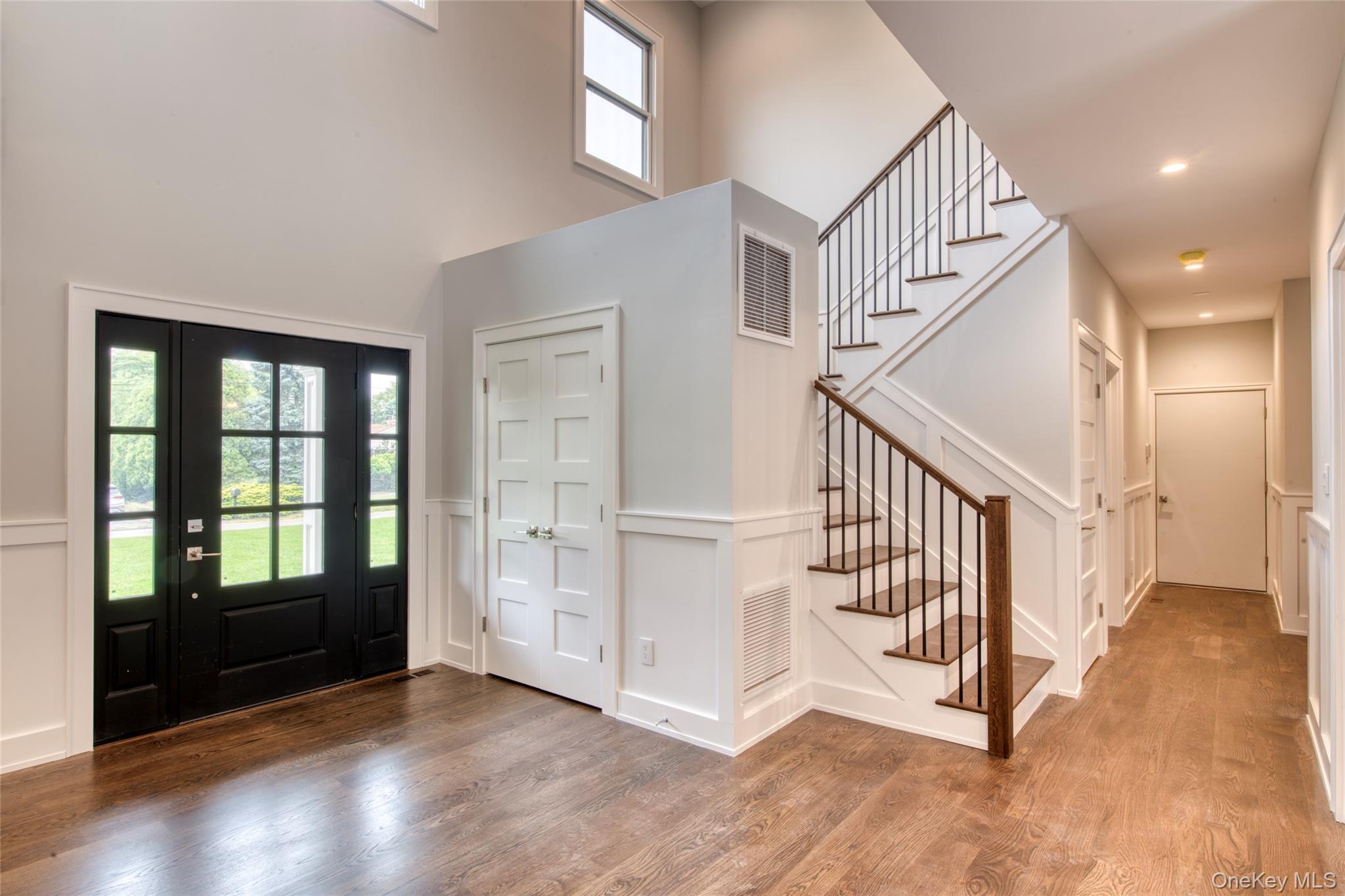 435 Maple Lane Greenport, NY 11944 - Photo 16 of 44 an entryway in a hall with wooden floor and windows