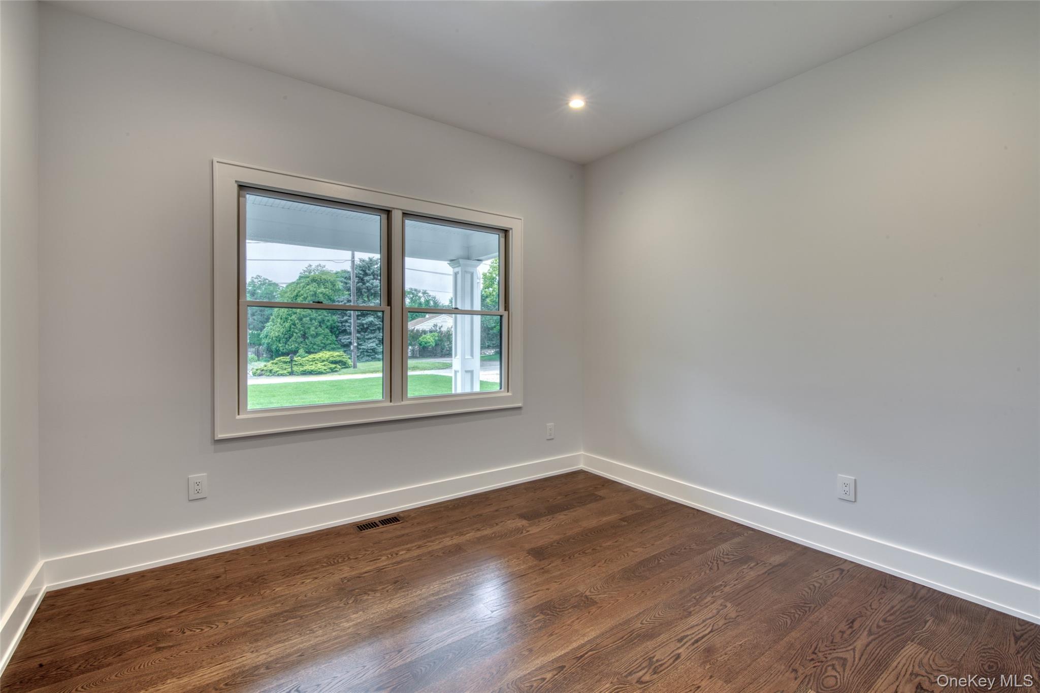 435 Maple Lane Greenport, NY 11944 - Photo 18 of 44 an empty room with wooden floor and window