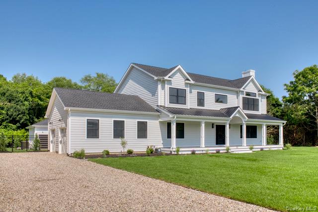 435 Maple Lane Greenport, NY 11944 - Photo 2 of 44 a front view of a house with a garden