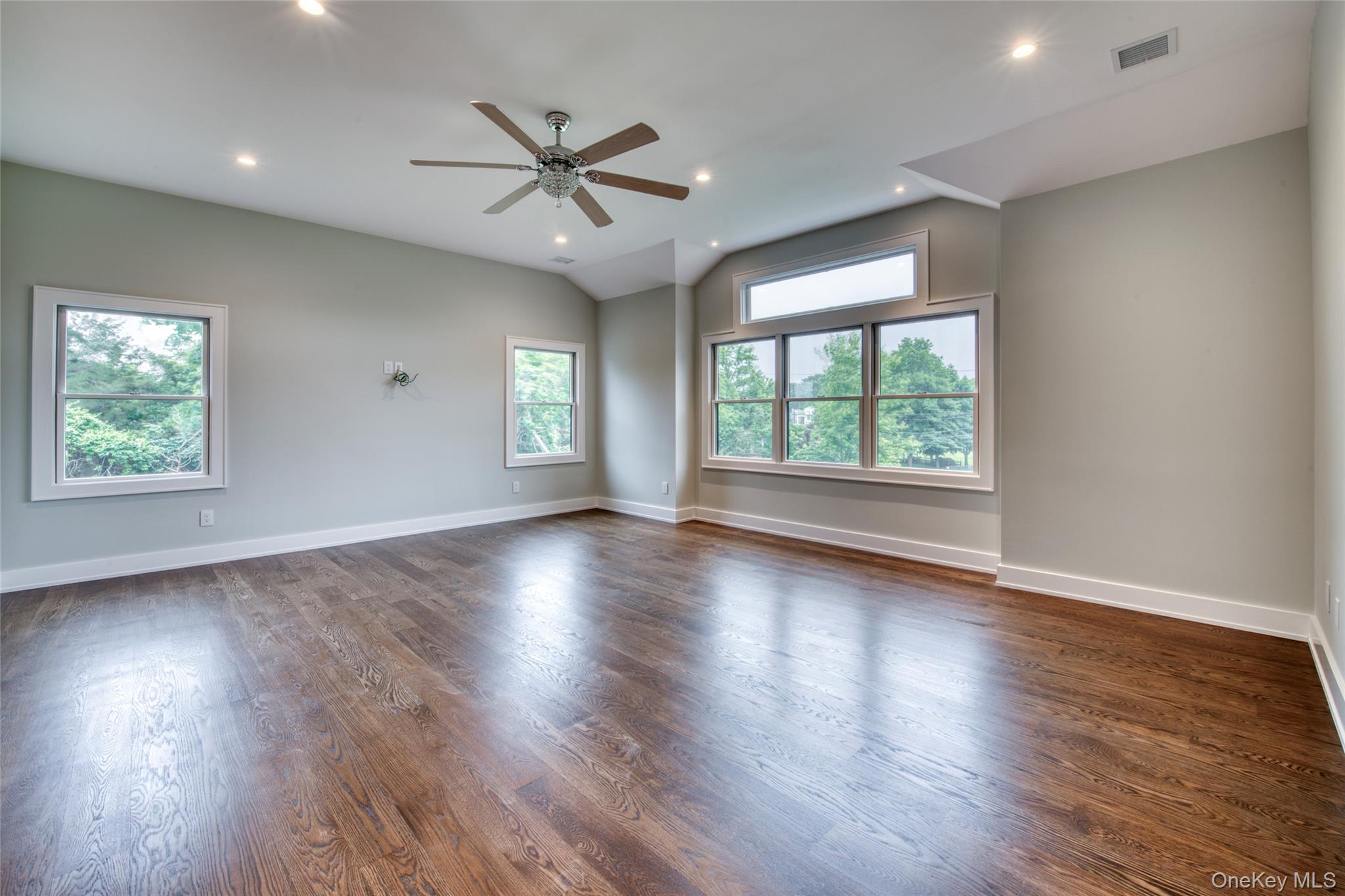 435 Maple Lane Greenport, NY 11944 - Photo 22 of 44 a view of an empty room with wooden floor and a window