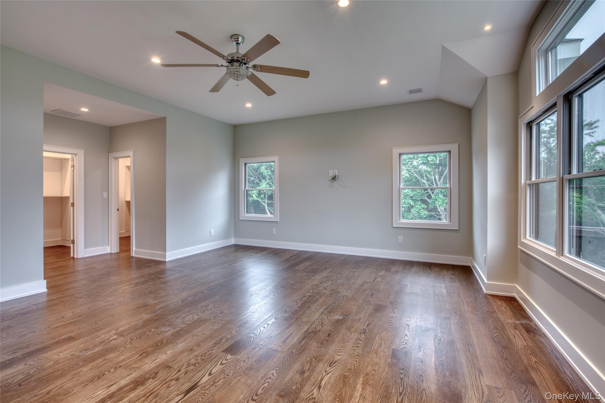 435 Maple Lane Greenport, NY 11944 - Photo 23 of 44 an empty room with wooden floor and windows