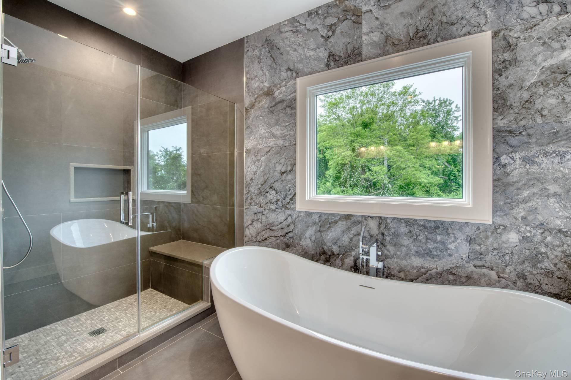 435 Maple Lane Greenport, NY 11944 - Photo 28 of 44 a bath tub sitting in a bathroom next to a window