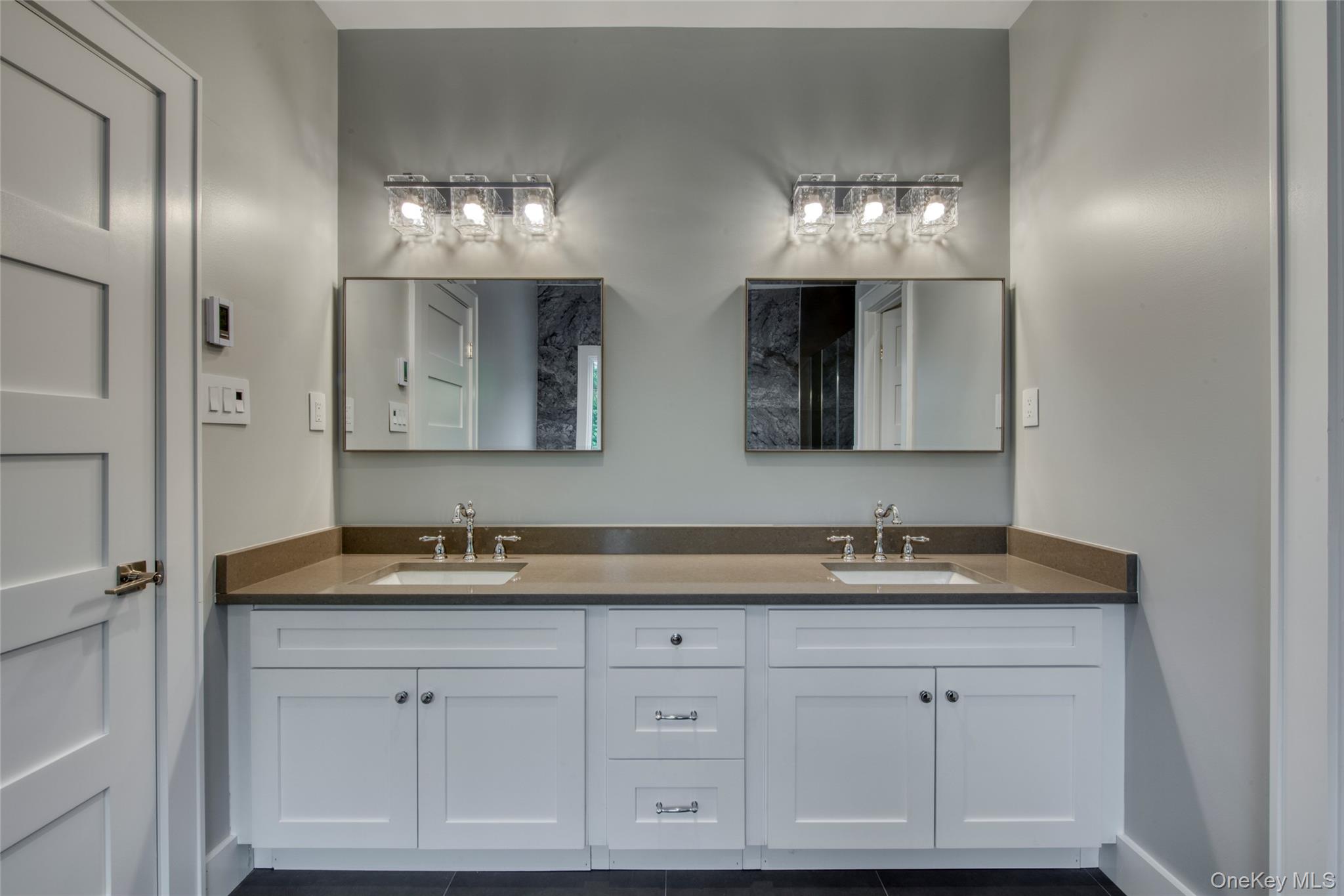 435 Maple Lane Greenport, NY 11944 - Photo 30 of 44 a bathroom with double sink and a mirror