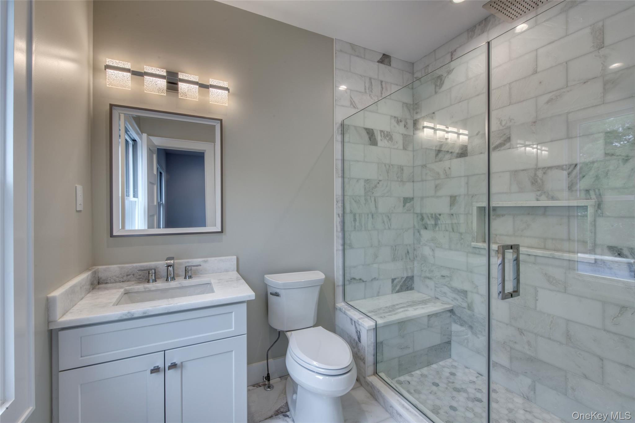 435 Maple Lane Greenport, NY 11944 - Photo 32 of 44 a bathroom with a granite countertop sink a toilet and shower
