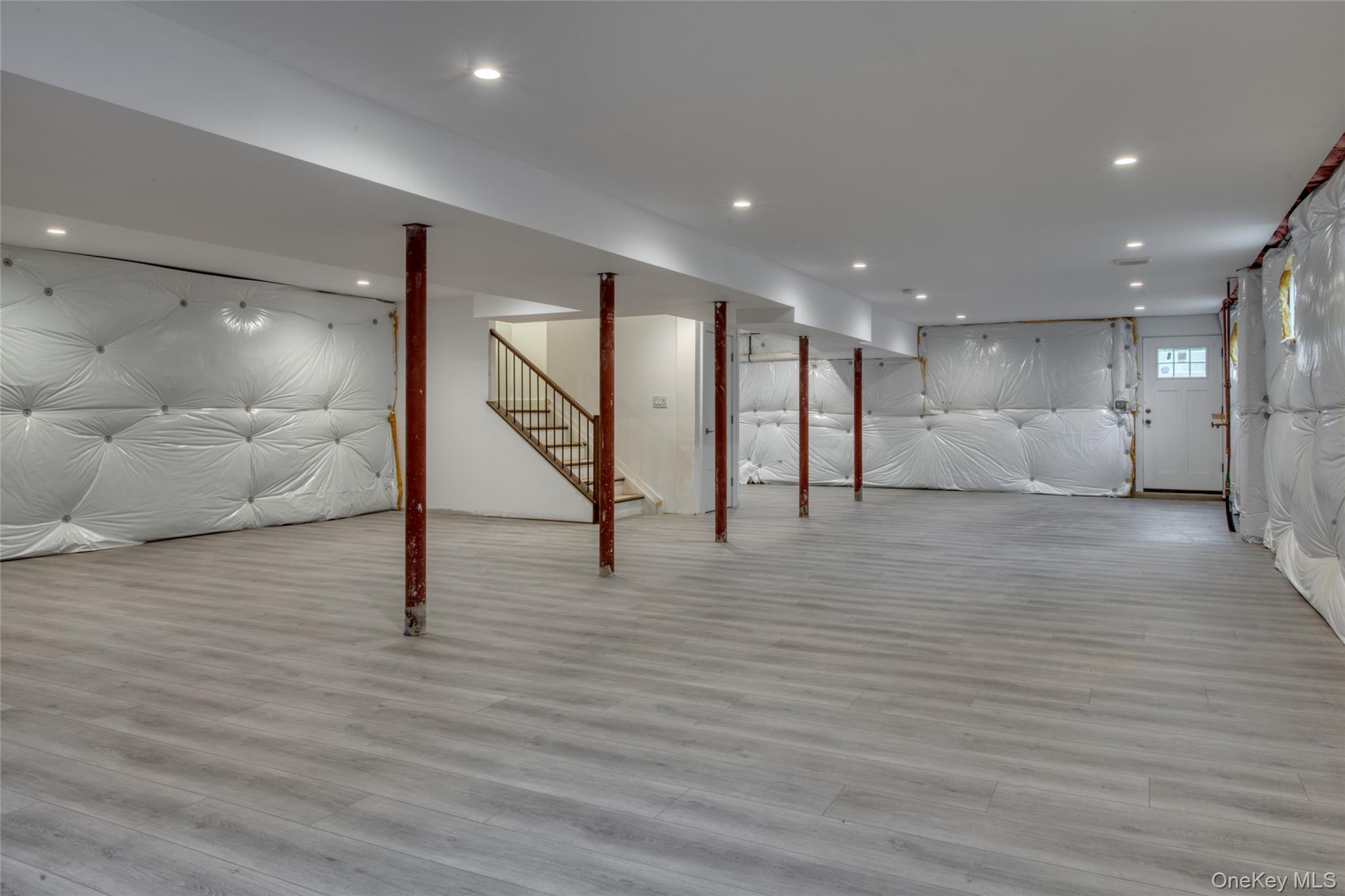 435 Maple Lane Greenport, NY 11944 - Photo 38 of 44 a view of an empty room with wooden floor