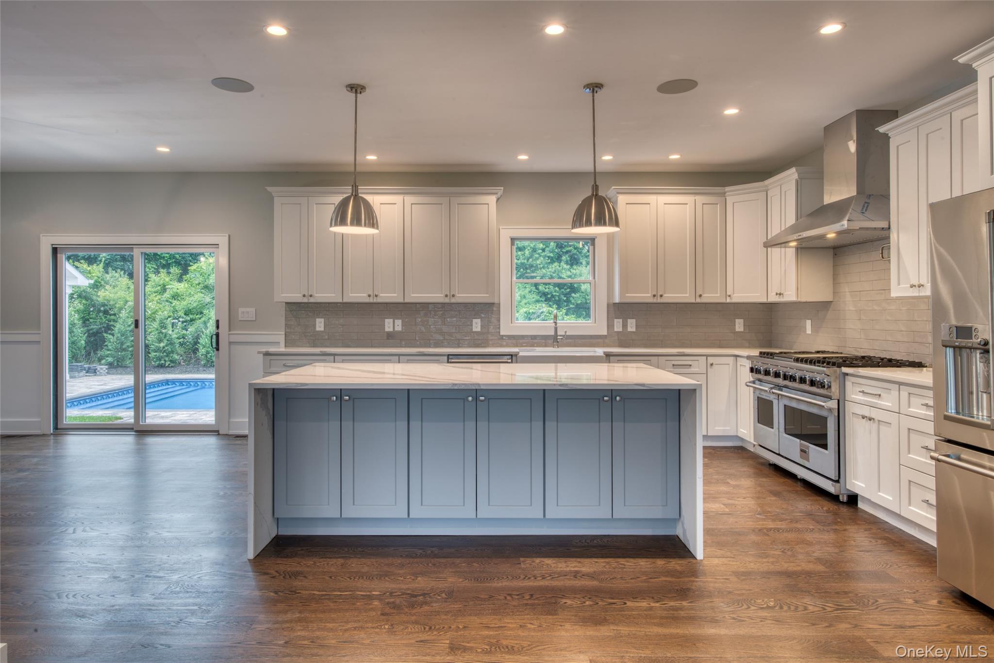 435 Maple Lane Greenport, NY 11944 - Photo 7 of 44 a kitchen with kitchen island granite countertop a stove a sink and a wooden cabinets