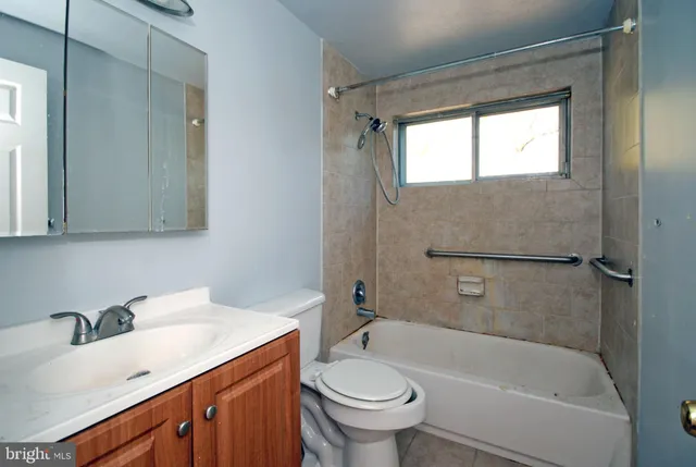 a bathroom with a sink toilet and mirror