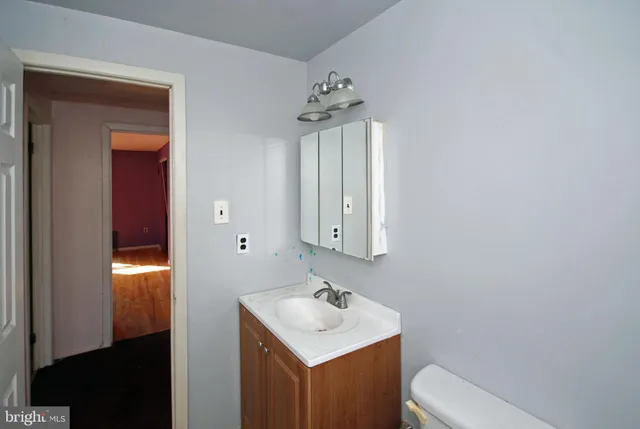 a view of a hallway with wooden floor and stairs