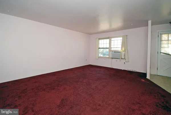 an empty room with a empty space and windows