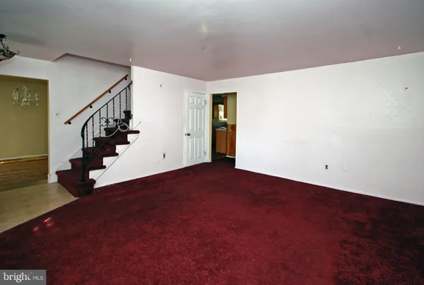 a view of an empty room with stairs
