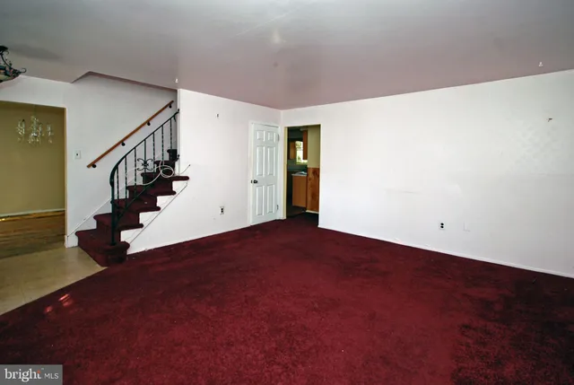 a view of an empty room with stairs