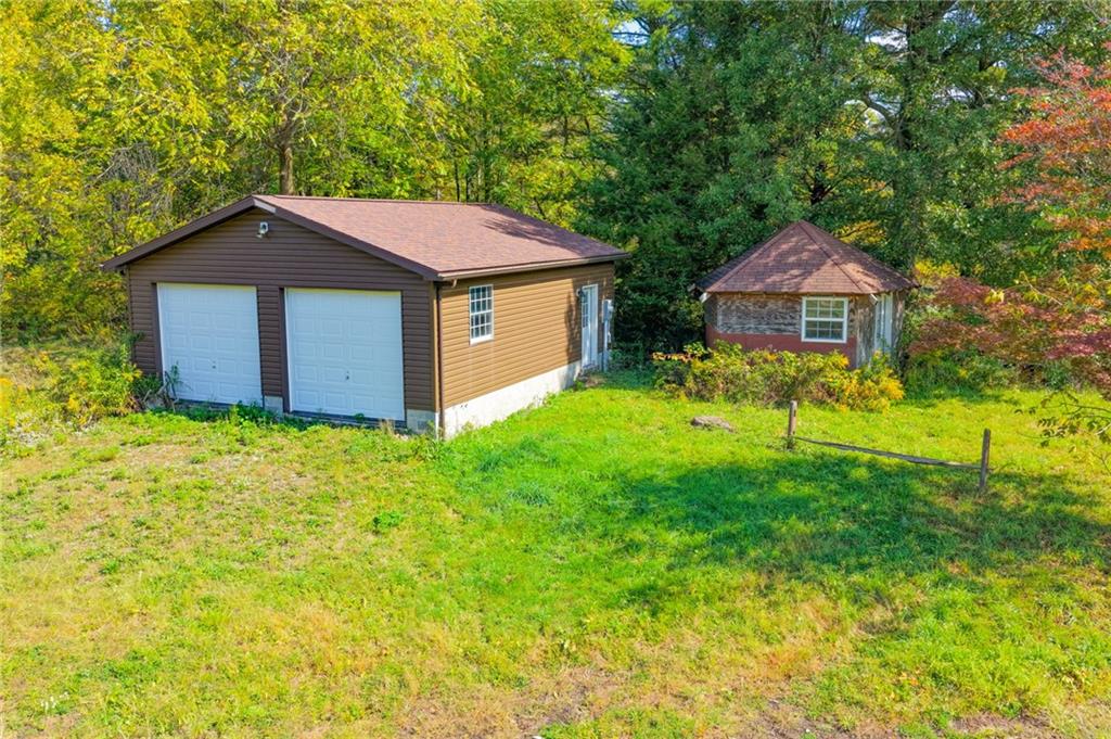 5673 Perry Highway Volant, PA 16156 - Photo 2 of 15 a backyard of a house with table and chairs