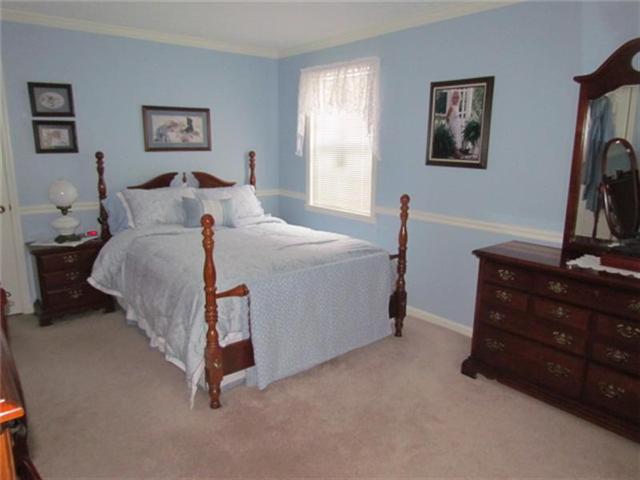 4016 New Chapel Road Springfield, TN 37172 - Photo 6 of 20 a bed room with a bed and a night stand