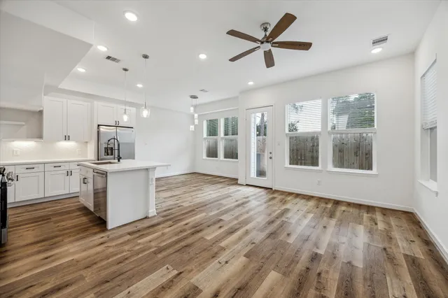 a view of kitchen with cabinets and wooden floor