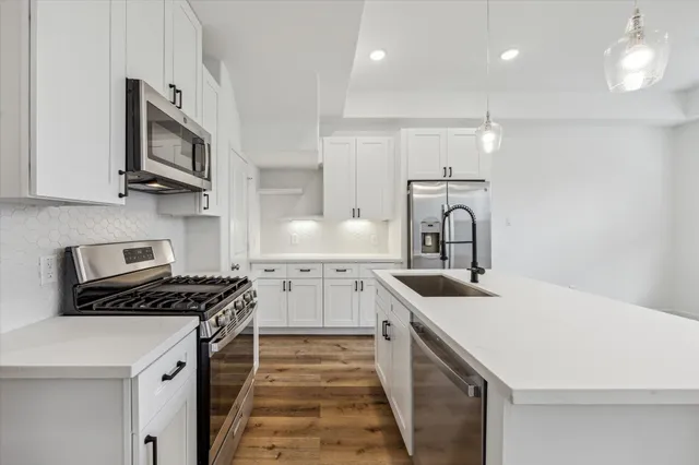 a kitchen that has a sink and a stove