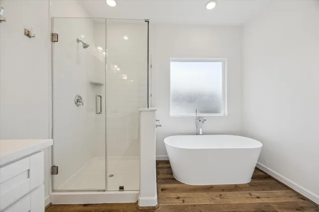 a bathroom with a bathtub and shower