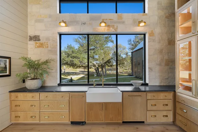 a kitchen with sink and large window
