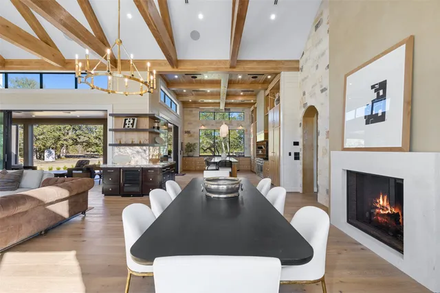 a dining room with furniture a fireplace and wooden floor