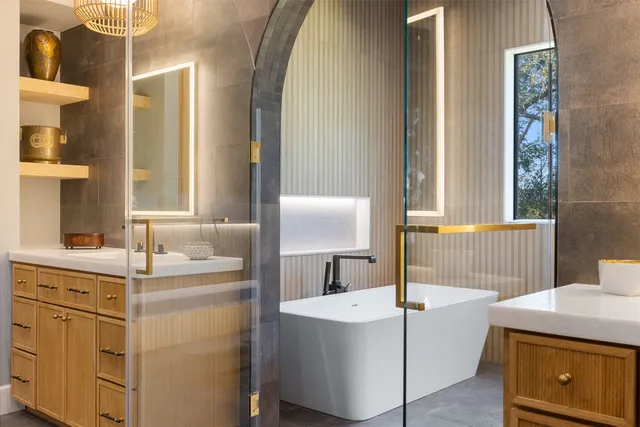 a large spacious bathroom with a granite countertop sink mirror and a bathtub
