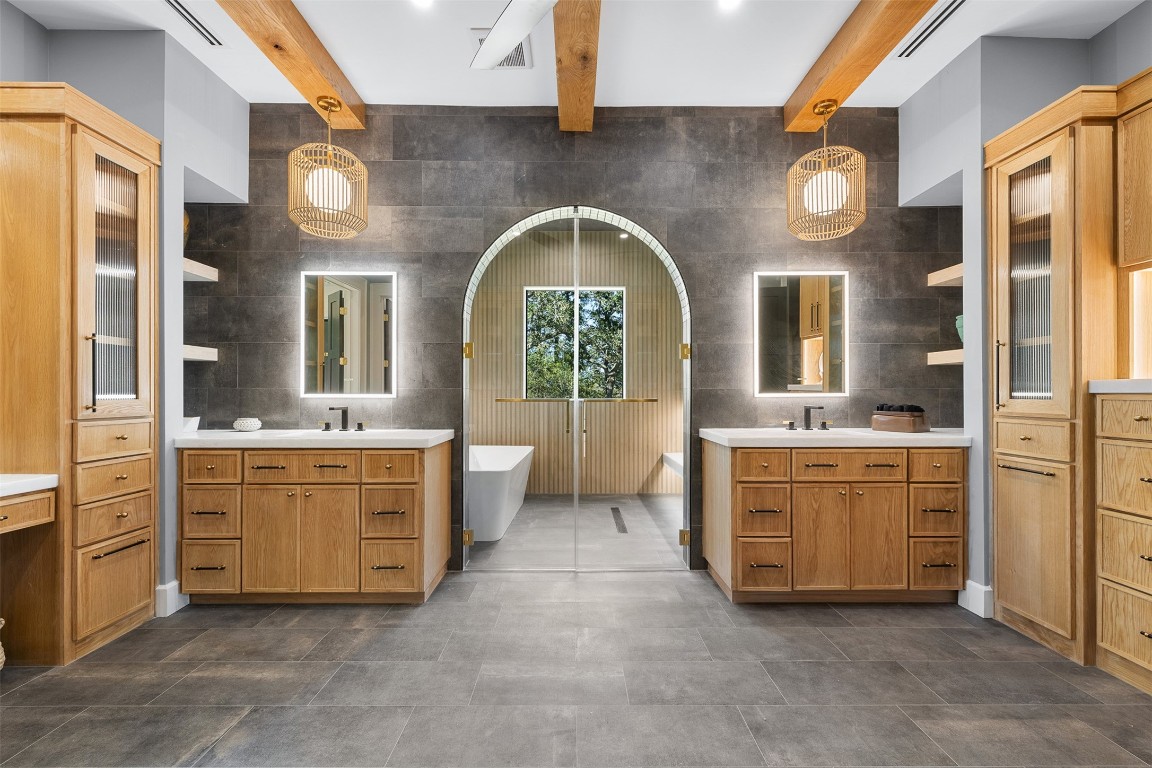 226 Hackemack Road Round Top, TX 78954 - Photo 36 of 50 a spacious bathroom with a granite countertop sink a mirror and bathtub