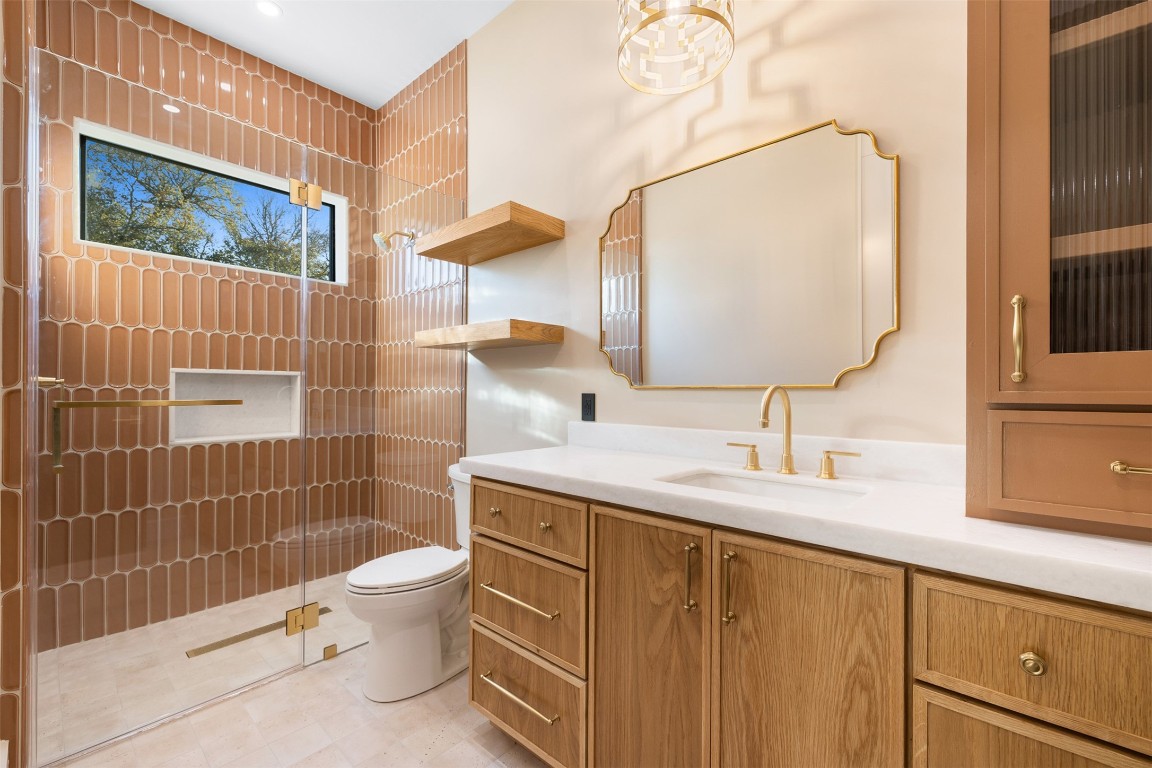 226 Hackemack Road Round Top, TX 78954 - Photo 40 of 50 a bathroom with a granite countertop sink a toilet and a mirror