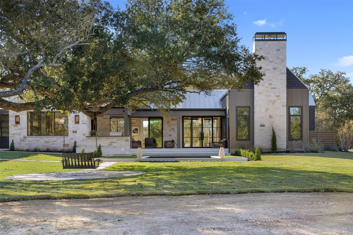 226 Hackemack Road Round Top, TX 78954 - Photo 5 of 50 a front view of a house with a yard table and chairs