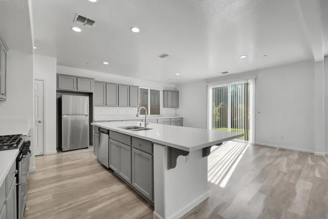 a large white kitchen with a large window