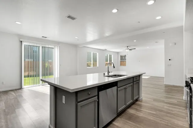 a kitchen with counter top space sink and center island
