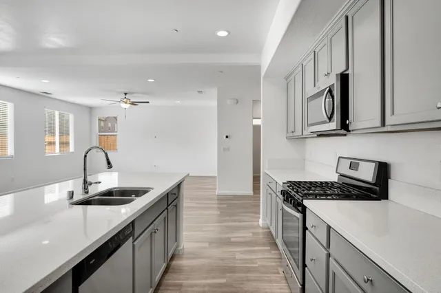 a kitchen with stainless steel appliances granite countertop a sink and cabinets