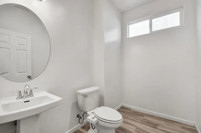 a white toilet sitting next to a bathroom sink