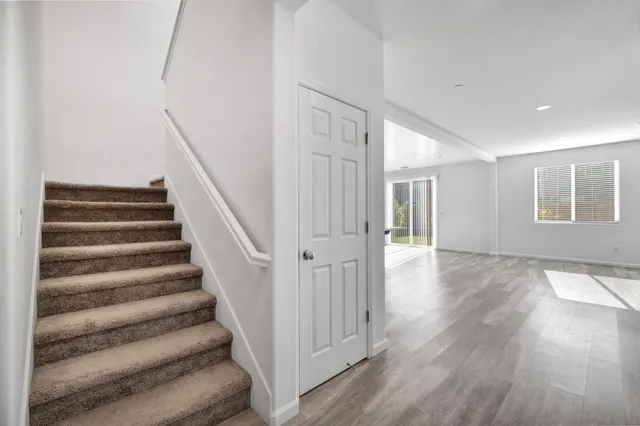 a view of entryway with wooden floor and stairs
