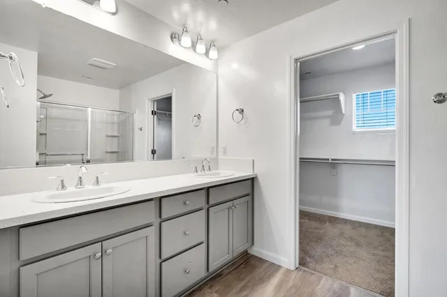 a bathroom with a double vanity sink and a mirror