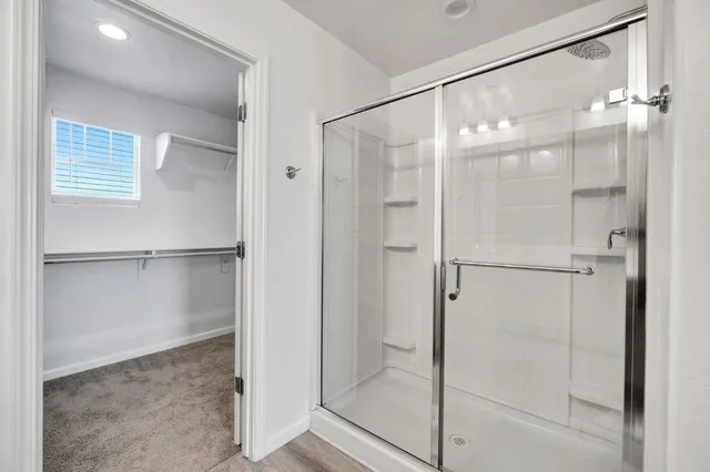 a bathroom with a glass shower door