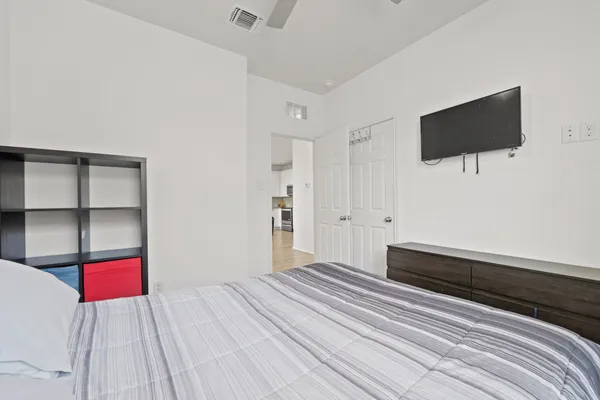 a bedroom with a bed and a chandelier