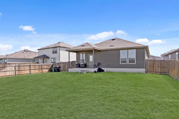 a view of a house with a backyard