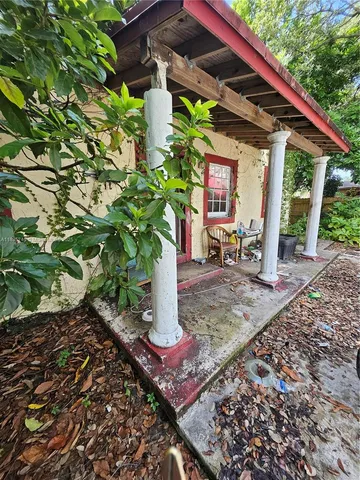 a view of a house with yard and sitting area