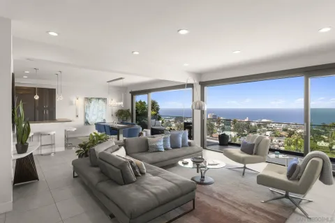 a view of a patio with couches chairs under an umbrella