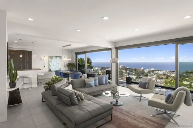 a view of a patio with couches chairs under an umbrella