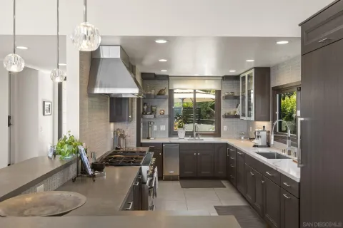 a large kitchen with a table and chairs