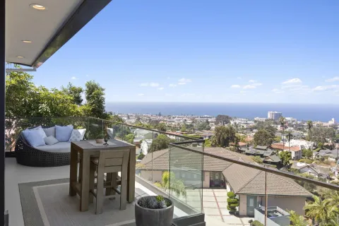 a living room with dining room and wooden floor