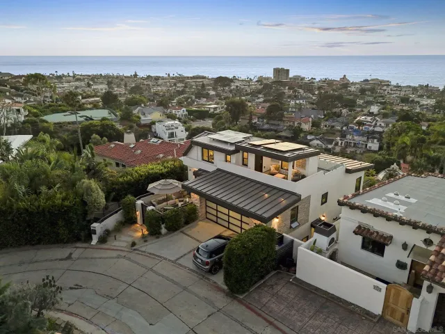 an aerial view of a house with a big yard