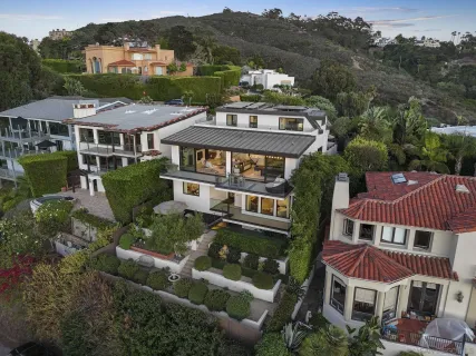a house with lots of trees in the background