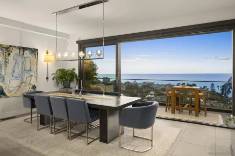 a dining room with furniture and a floor to ceiling window