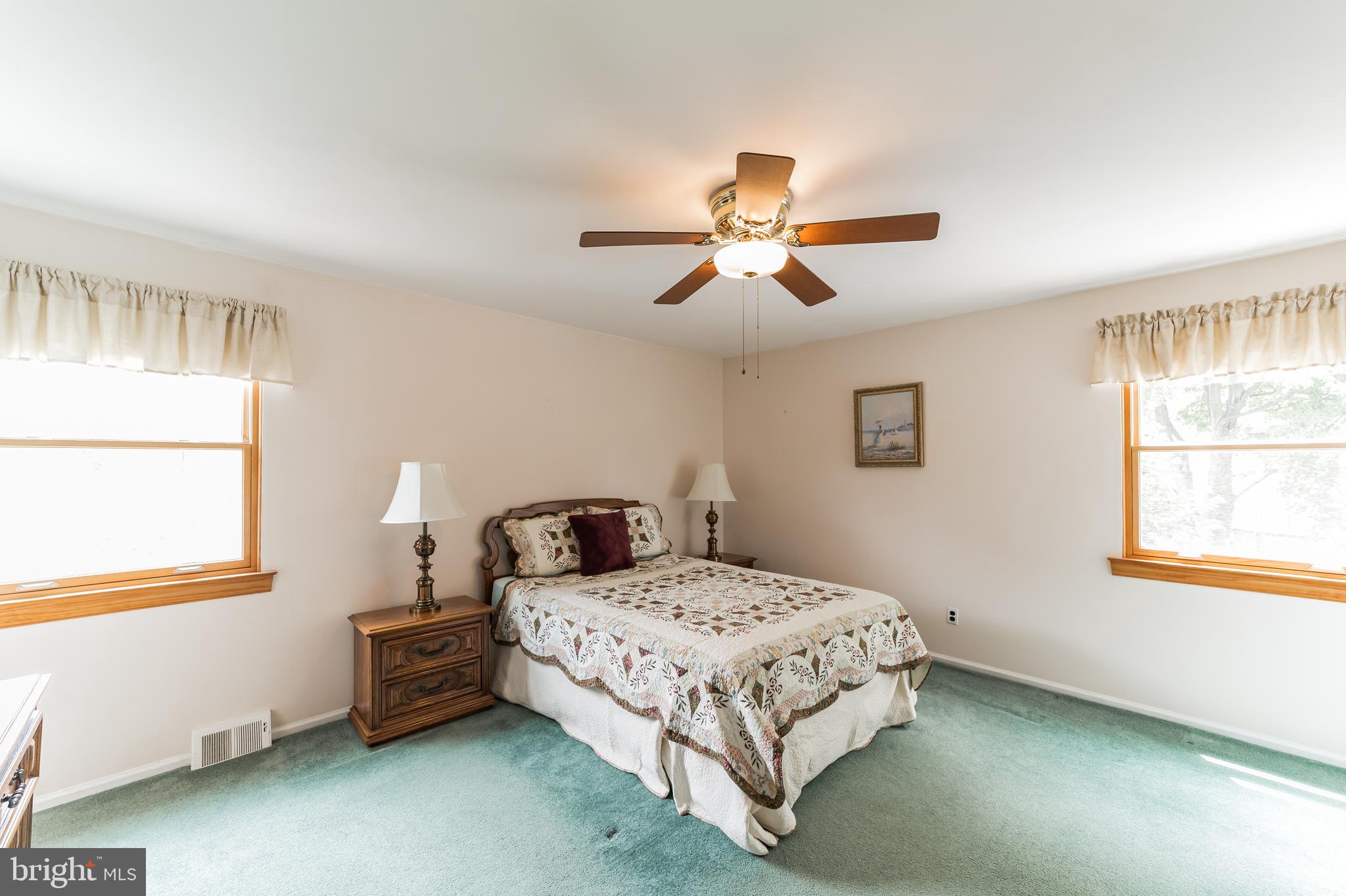 69 St Davids Road Springfield, PA 19064 - Photo 16 of 21 a bedroom with a bed a window and a chandelier