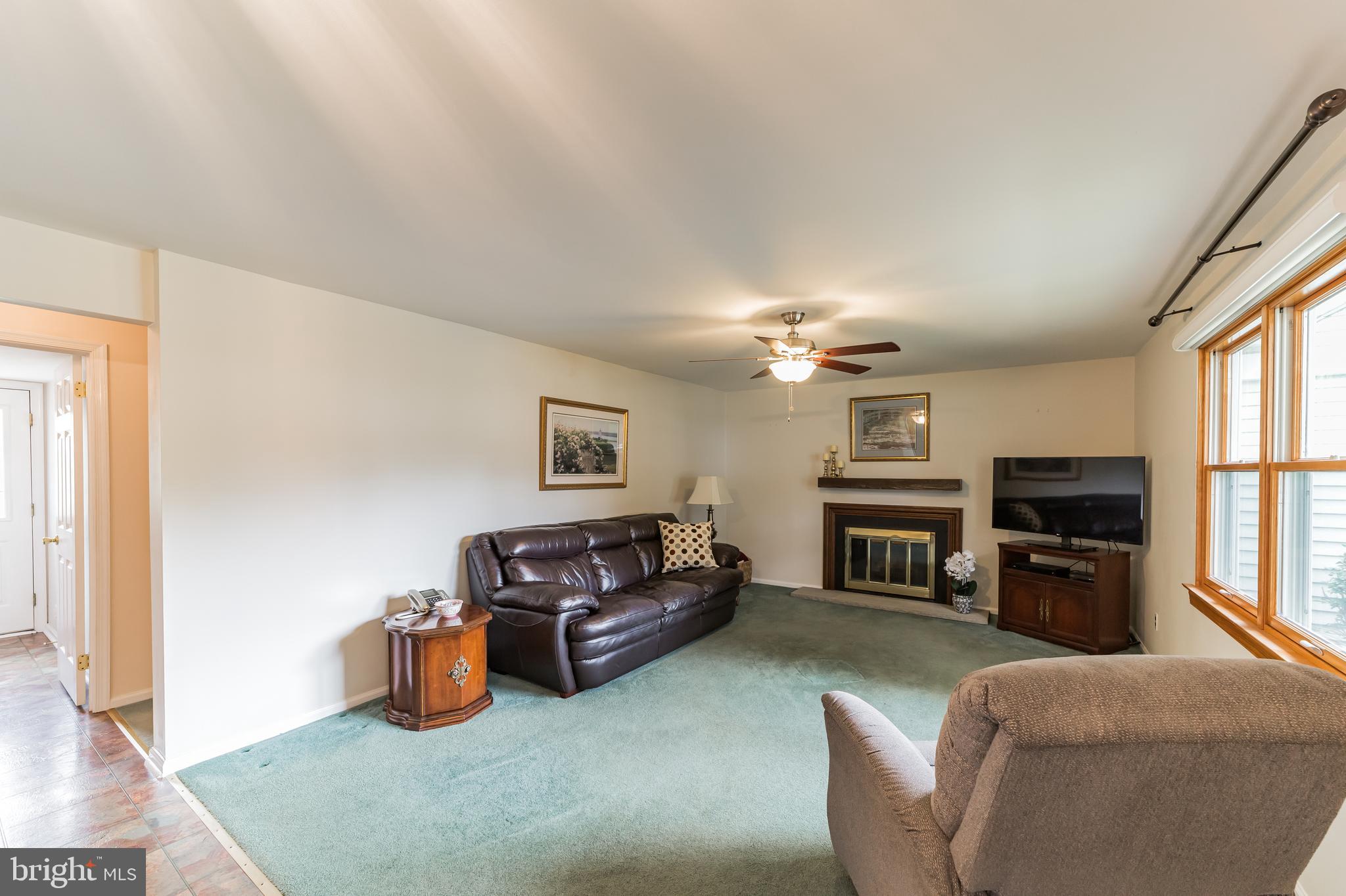 69 St Davids Road Springfield, PA 19064 - Photo 9 of 21 a living room with furniture a fireplace and a flat screen tv