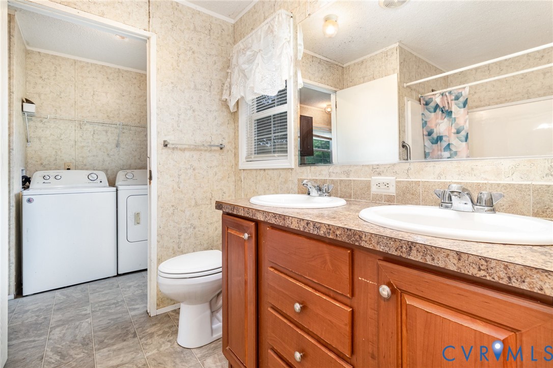 1292 Mt Prospect Road Laneview, VA 22504 - Photo 9 of 25 a bathroom with a granite countertop toilet sink and mirror