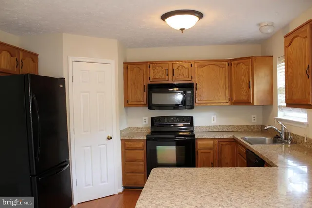 a kitchen with a refrigerator stove and a sink