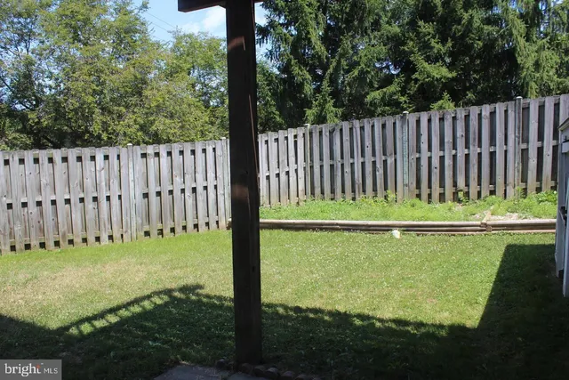 a view of a garden with a bench in a park